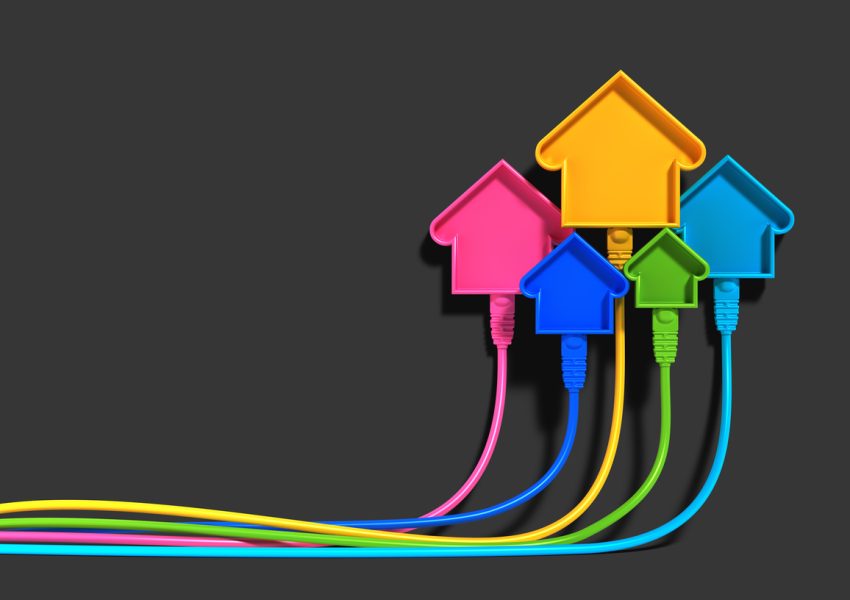 Illustration of multicolored house icons linked by ethernet cables on a black background, symbolizing smart homes, internet connectivity, and technology.