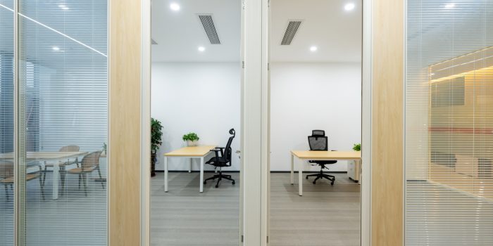 New desks, chairs, and glass blinds for the office of a small modern decor business.